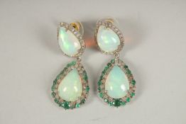 A SILVER AND GOLD PAIR OF OPAL, EMERALD AND DIAMOND DROP EARRINGS.
