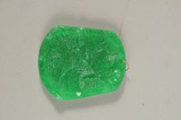 A GOLD RING TOP JADE PENDANT.