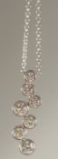 AN 18CT WHITE GOLD AND DIAMOND PENDANT with seven 