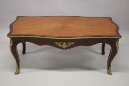 A LOUIS XVITH RECTANGULAR COFFEE TABLE with inlaid top, gilt mounts on four curving legs. 126cms