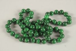 A STRING OF JADE BEADS. 80cms long.