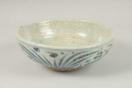 A CHINESE BLUE AND WHITE BOWL decorated with fish. 26cms diameter.