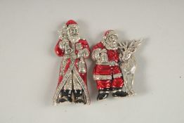 TWO SILVER ENAMEL FATHER CHRISTMAS BROOCHES.
