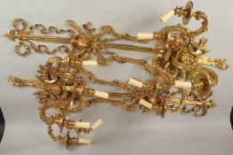 A GOOD PAIR OF LARGE FOUR-LIGHT GILT BRONZE WALL SCONCES with ribbon motifs, masks and acanthus.