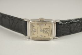 A MILTON GOLDEN PLATINUM AND DIAMOND WRISTWATCH.
