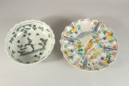 AN 18TH CENTURY TIN GLAZE BOWL 23cms diameter and a dish with brilliant colours, with a bird,
