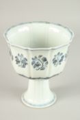 A CHINEE BLUE AND WHITE PORCELAIN STEM CUP, the interior painted with a bird. 17.5cms high.