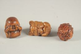 THREE CARVED WOOD NETSUKES.