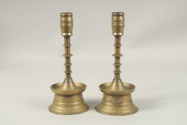 A PAIR OF 17TH CENTURY DUTCH BRASS CANDLESTICKS. 25cms high.