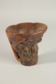 A CARVED HORN LIBATION CUP. 14cms high.