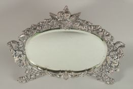 A SILVER PLATED OVAL EASEL MIRROR. Mirror 18cms x 27cms.