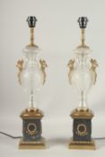 A GOOD PAIR OF CUT GLASS URN SHAPED LAMPS on pedestal bases.