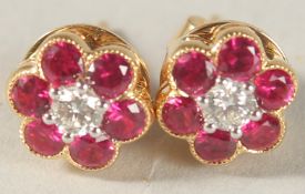 A PAIR OF 18CT YELLOW GOLD, RUBY AND DIAMOND FLOWER HEAD CLUSTER EAR STUDS.