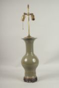 A CHINESE GREEN CRACKLE GLAZE LAMP on a wooden base.