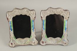 A GOOD PAIR OF ART NOUVEAU SILVER AND BLUE ENAMEL BUTTERFLY PHOTOGRAPH FRAMES. 20cms x 15cms.