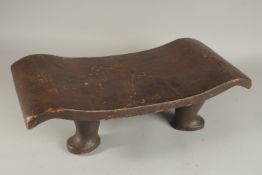 A RARE COOK ISLANDS STOOL on four pad feet. 50cms high x 24cms wide x 13cms long.