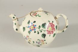 A LARGE POTTERY TEAPOT AND COVER painted with flowers. 12cms high (AF).