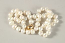 A PEARL NECKLACE with gold clasp. 50cms long.