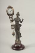 A DIANA SWING CLOCK on a circular wooden base. 30cms high.