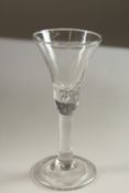 A GEORGIAN WINE GLASS with tapering bowl, air bubble and plain stem. 14cms high.