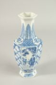 A CHINESE BLUE AND WHITE VASE with panels of figures. 24cms high.