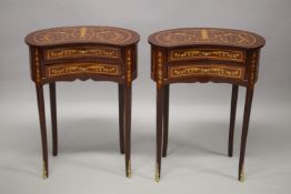 A PAIR OF LOUIS XVITH DESIGN KIDNEY SHAPED BEDSIDE TABLES with two drawers, on curving legs. 76cms