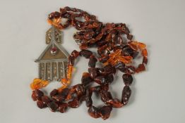 A LARGE FOUR ROW AMBER NECKLACE with PENDANT.