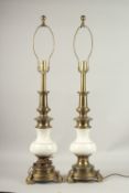A PAIR OF BRASS AND WHITE PORCELAIN STIFFEL LAMPS. 56cms high.