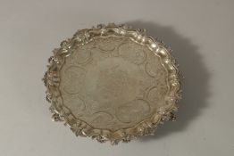 A GEORGIAN ENGRAVED SALVER with engraved crest. 20cms diameter. Maker: H. C.