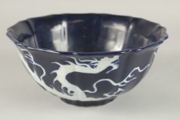 A CHINESE SACRIFICIAL BLUE GLAZE WHITE DRAGON PETAL FORM BOWL. 23cms wide.