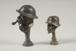 TWO REPLICA BRONZE WWI TAMPER SEALS.