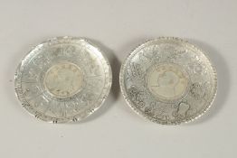 A PAIR OF CHINESE COIN DISHES. 9cms diameter.