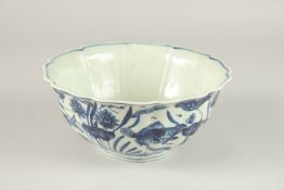 A CHINESE BLUE AND WHITE PETAL SHAPE BOWL, with fish and algae. 22.5cms wide.