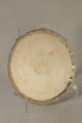 A GOLDSMITHS AND SILVERSMITHS CIRCULAR SALVER with pie crust edge, on four claw and ball feet.