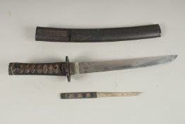 A 17TH CENTURY JAPANESE TANTO with bound shagreen handle. Tsuba. Polished blade in a lacquer sheath.