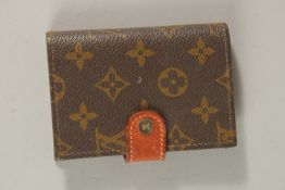 A LOUIS VUITTON PURSE.