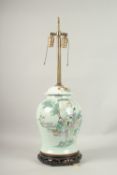A CHINESE PORCELAIN TEMPLE VASE on a wooden base, as a lamp.
