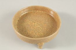 A CIRCULAR CRACKLE GLAZE PORCELAIN CENSER on three legs. 13cms diameter.
