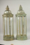 A LARGE PAIR OF GREEN METAL CIRCULAR LANTERNS. 86cms high.