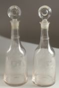 A GOOD PAIR OF ENGRAVED DECANTERS AND STOPPERS, Summer and Winter. 30cms high.