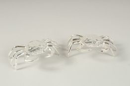 A SMALL PAIR OF PLATED CRAB SALTS.