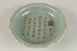 A CHINESE CELADON CRACKLE GLAZE PETAL FORM BOWL, with gilt characters. 18.5cms diameter.