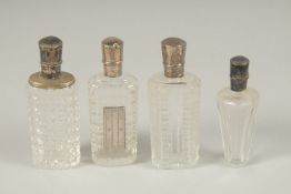 FOUR SILVER TOP SCENT BOTTLES.