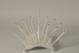 A CHRISTOPHER DRESSER DESIGN SIX DIVISION TOAST RACK.