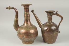 A PERSIAN SAFAVID ENGRAVED COPPER EWER, together with another engraved tinned copper ewer, 33cm