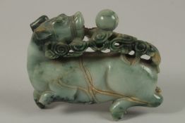 A CHINESE CARVED JADE FIGURE OF A BULL, 13cm long.