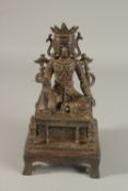A CHINESE BRONZE SEATED BUDDHA, raised on a square-form plinth with traces of gilding, 25cm high.