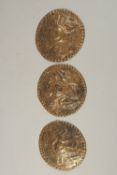 A COLLECTION OF THREE 18TH-19TH CENTURY OTTOMAN ARMENIAN GILT COPPER CIRCULAR PLAQUES, depicting