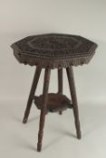 A 19TH CENTURY KASHMIRI CARVED WOOD TABLE, with octagonal top carved with foliate scrolls, 60cm