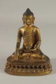 A TIBETAN GILT BRONZE SEATED BUDDHA ON LOTUS BASE, 20cm high.